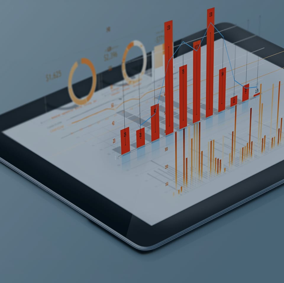 A tablet displays a detailed financial graph with bar charts, line graphs, and pie charts. The main bar chart has red bars of varying heights indicating different values. The background is a muted blue, emphasizing the digital financial analytics on the screen.