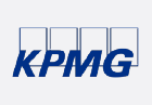 The image shows the KPMG logo consisting of the letters "KPMG" in bold, dark blue text. The letters are partially enclosed in four outlined rectangles, each containing one letter, against a white background. KPMG is a multinational professional services network.